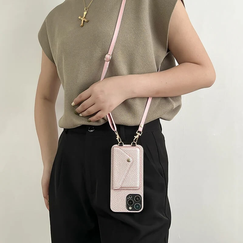 Woman wearing a pink crossbody wallet phone case with adjustable strap